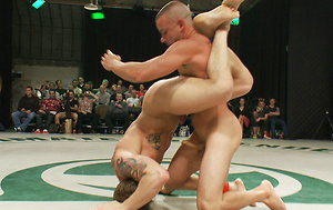 Four big dicked muscle studs fight it out to win the right to humiliate and fuck the losers in front of a live crowd in this brutal tag team match. by Naked Kombat image 7